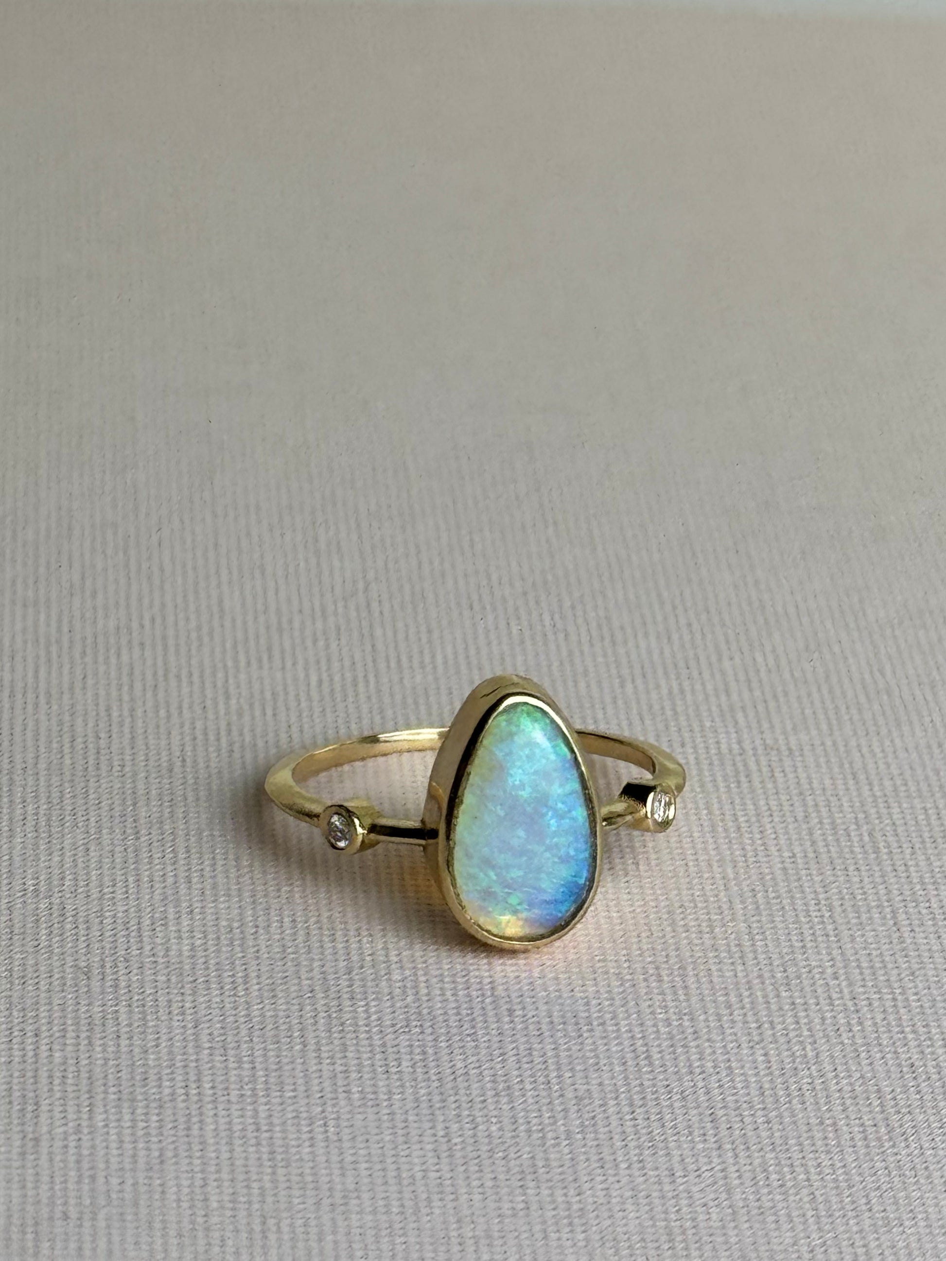 18k Solid gold crystal opal blue ring with diamonds, front view